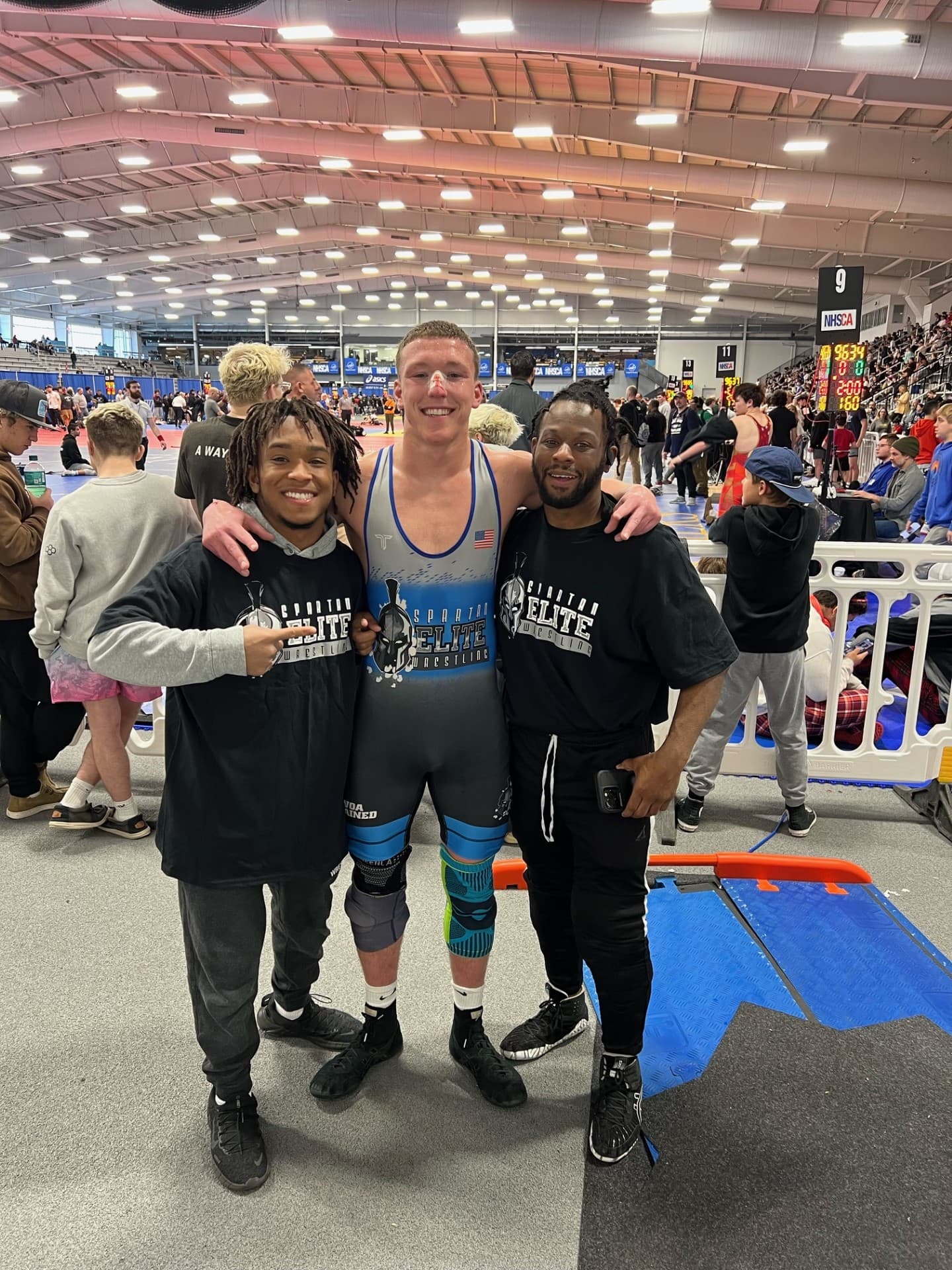 Spartan Elite coaches with athlete at national tournament